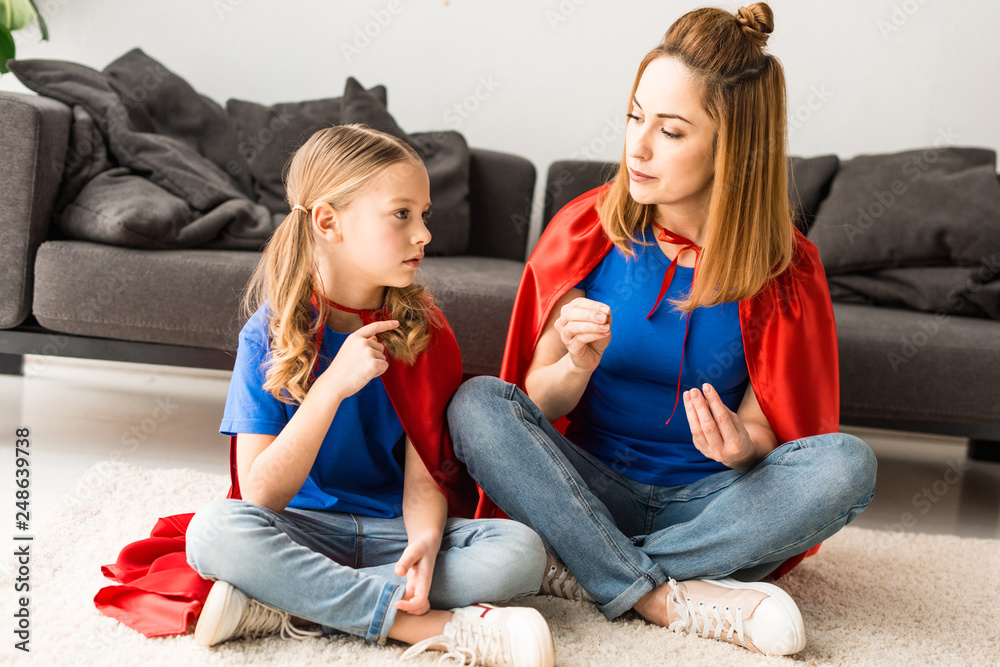daughter and mother sitting on floor and talking at home daughter and mother sitting on floor and talking at home