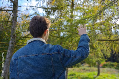 Teenage boy looking in forest