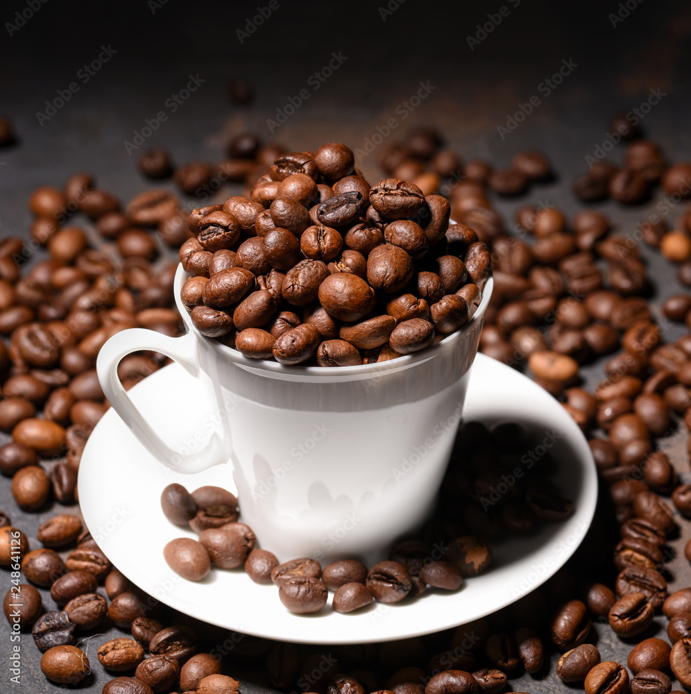 Coffee beans in coffee cup on black background Coffee beans in coffee cup on black background