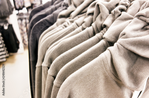 A row of pullovers hanging in store. © rosinka79