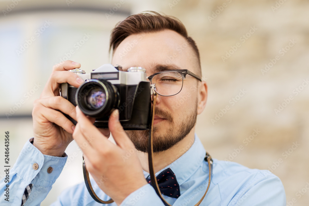 photography, technology and lifestyle - young photographer or hipster man with vintage film camera outdoors photography, technology and lifestyle - young photographer or hipster man with vintage film camera outdoors