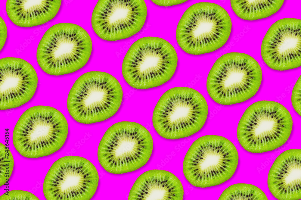 Diagonal rows of five pieces of fresh ripe kiwi on pink background Diagonal rows of five pieces of fresh ripe kiwi on pink background