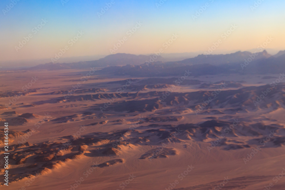 Aerial view of Arabian desert and mountain range Red Sea Hills near Hurghada, Egypt. View from airplane