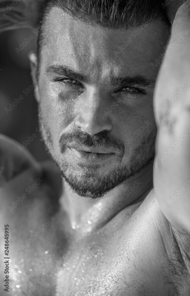 Vertical portrait of a handsome caucasian male model posing on the beach Vertical portrait of a handsome caucasian male model posing on the beach