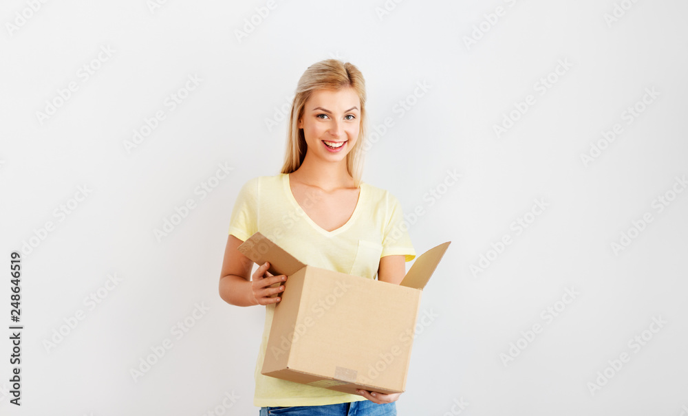 people and moving to new place concept - happy woman holding cardboard box people and moving to new place concept - happy woman holding cardboard box