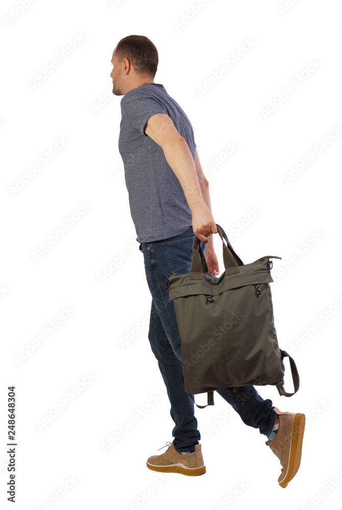Side view of walking man with green bag. Side view of walking man with green bag.