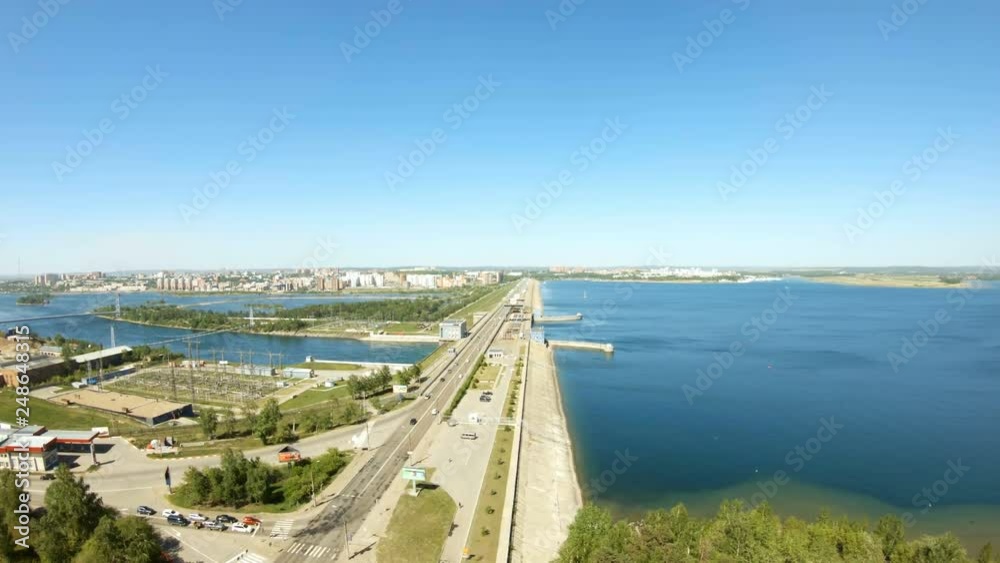 Aerial view of hydroelectric power station. Drone flies down. Road traffic cars. Aerial view of hydroelectric power station. Drone flies down. Road traffic cars.