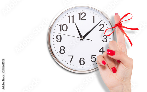 Red bow on finger and clock isolated on white.