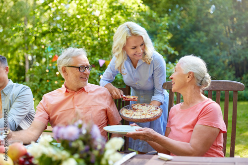 leisure  holidays and people concept - happy family having festive dinner or summer garden party