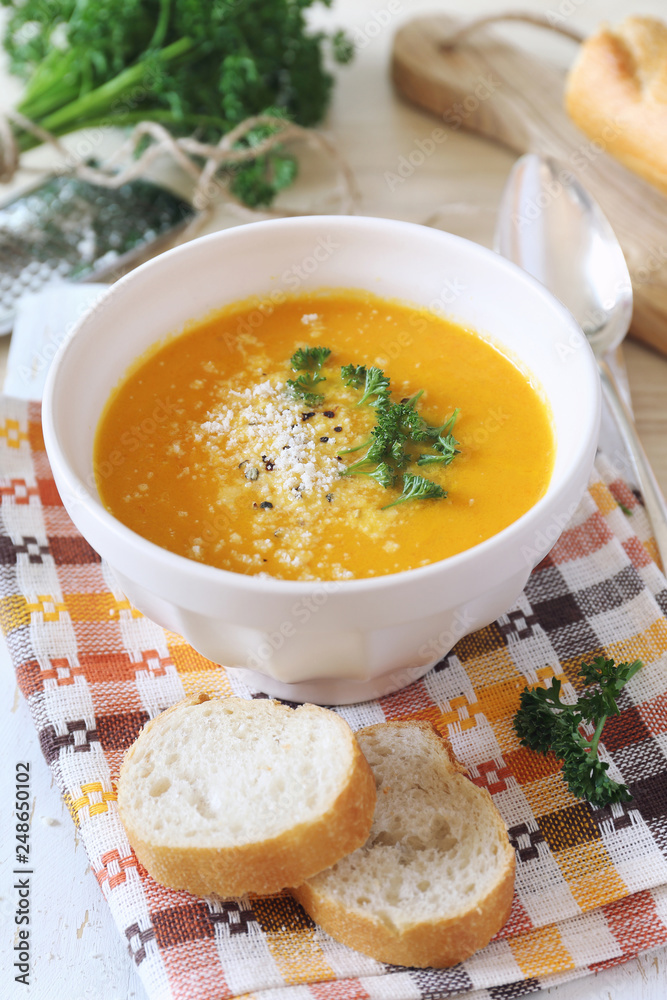 Vegetable carrot cream soup with parsley and grated cheese Vegetable carrot cream soup with parsley and grated cheese