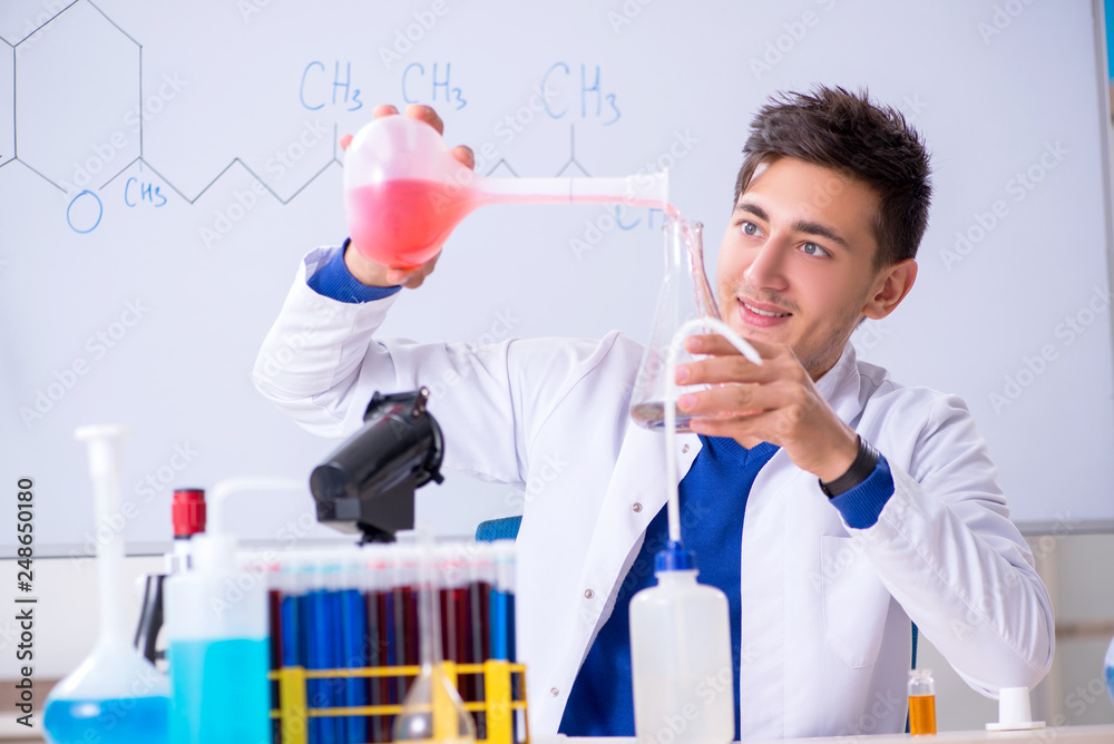 Young chemist sitting in the lab Young chemist sitting in the lab