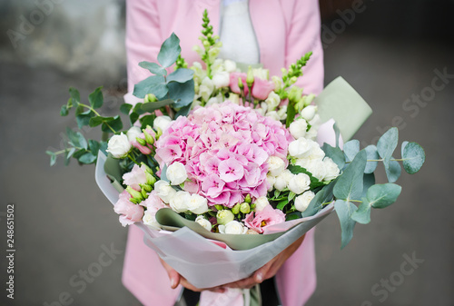 Obraz na płótnie Woman holding bouquet of beautiful flowers in hands. 8 March woman day. Hydrangea, rose, eustoma, eucalyptus. w salonie