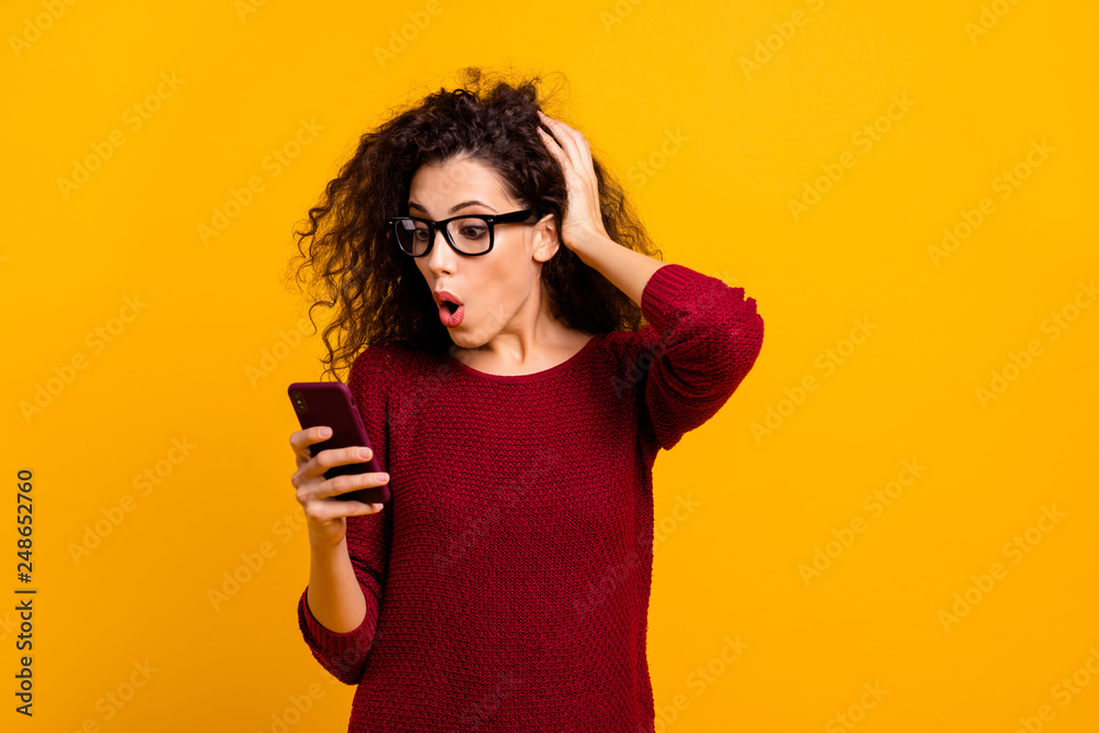 Portrait of her she nice cute attractive pretty adorable cheerful amazed wavy-haired lady holding in hands cell incredible omg notification isolated over bright vivid shine orange background Portrait of her she nice cute attractive pretty adorable cheerful amazed wavy-haired lady holding in hands cell incredible omg notification isolated over bright vivid shine orange background