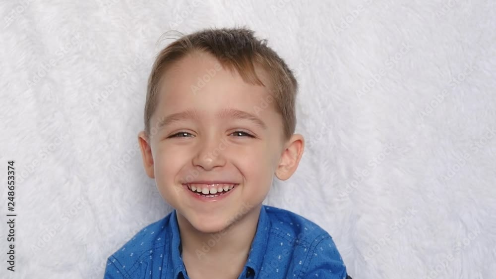 Close-up of a cute European appearance boy. Portrait of a happy child. A child laughs looking into the camera. Close-up of a cute European appearance boy. Portrait of a happy child. A child laughs looking into the camera.
