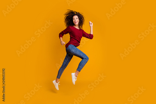 Full length body size view of her she nice-looking lovely pretty attractive cheerful cheery sportive slim fit wavy-haired lady running strive purpose isolated on bright vivid shine orange background