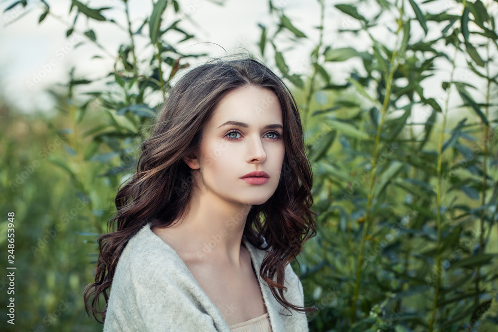 Pretty model woman with brown curly hairstyle outdoors Pretty model woman with brown curly hairstyle outdoors