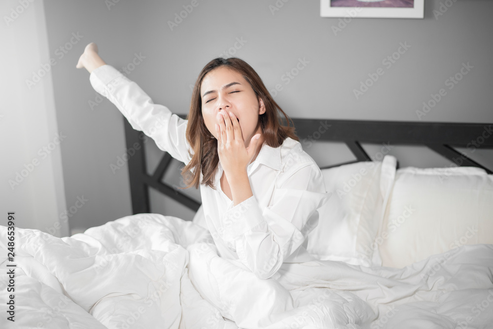 Beautiful woman is wake up on bed in morning Beautiful woman is wake up on bed in morning