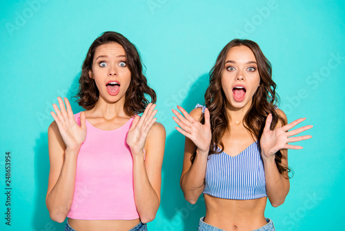 Close up portrait two amazing beautiful yelling she her lady meeting gathering unexpected news open mouth really cool wearing colored shiny shorts tank tops isolated teal bright vivid background