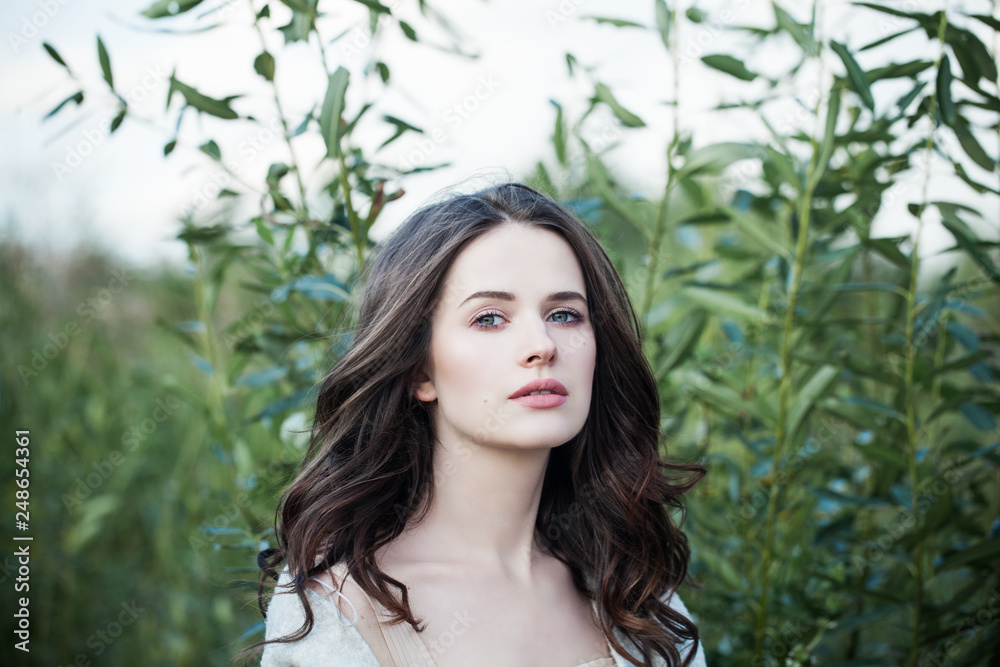 Beauty woman walking in spring park alone. Perfect young face closeup portrait outdoors. Beautiful romantic girl Beauty woman walking in spring park alone. Perfect young face closeup portrait outdoors. Beautiful romantic girl