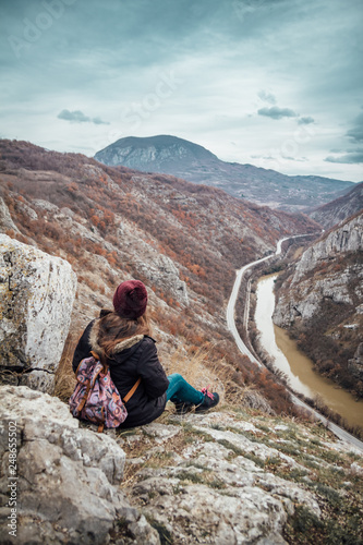 Girl sitting on the edge of the canyon