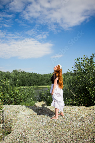 Young beautiful redhead woman on the stone © Julia
