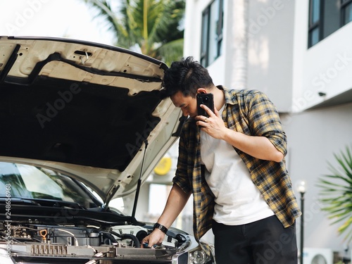 man repairing car © Mallika