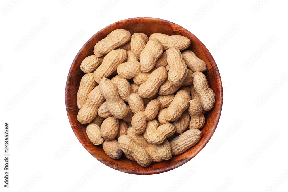 Peanuts in shells inside round wooden bowl isolated on white. Helathy vegetarian diet food background with empty copy space. Peanuts in shells inside round wooden bowl isolated on white. Helathy vegetarian diet food background with empty copy space.