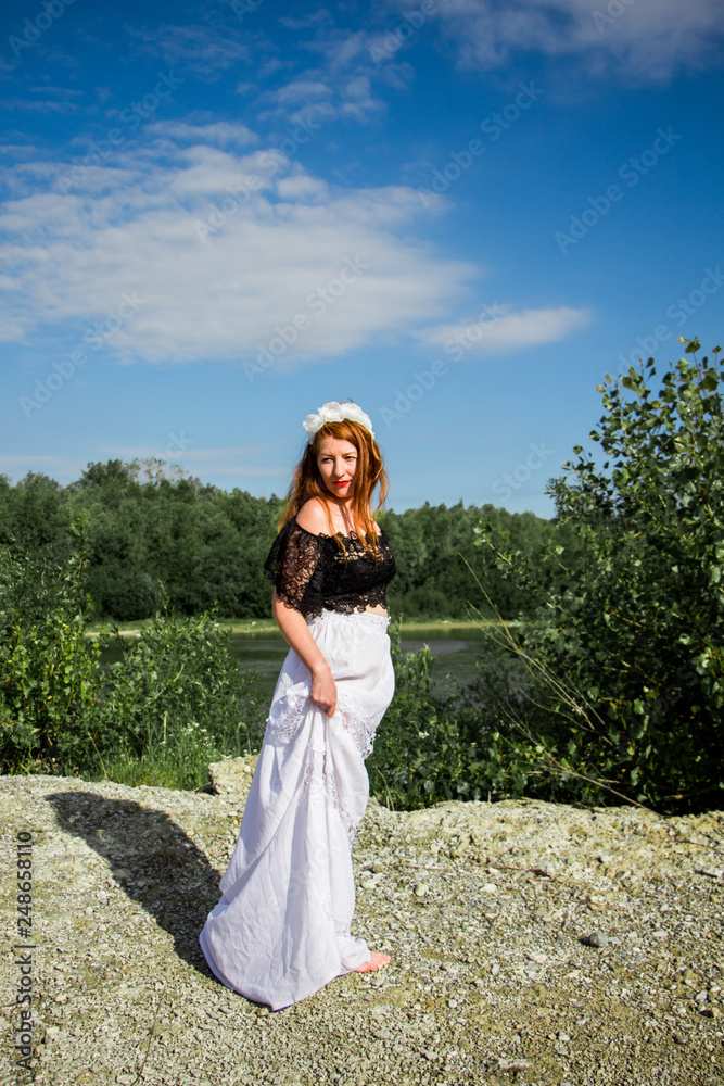Young beautiful redhead woman on the stone Young beautiful redhead woman on the stone