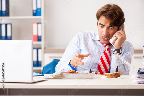 Employee eating food with cockroaches crawling around