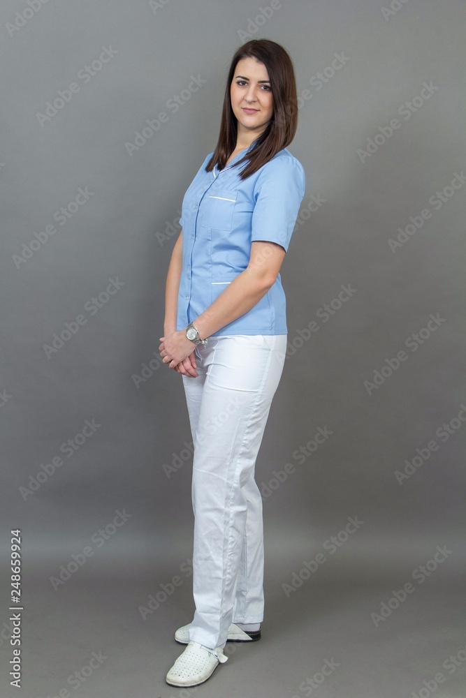 Young female nurse on greay background, isolated Young female nurse on greay background, isolated