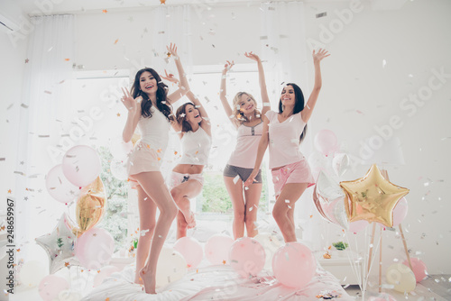 Full length body size portrait of nice-looking attractive lovely girlish feminine charming fit thin slim graceful cheerful girlfriends having fun showing v-sign in light white interior decorated house photo