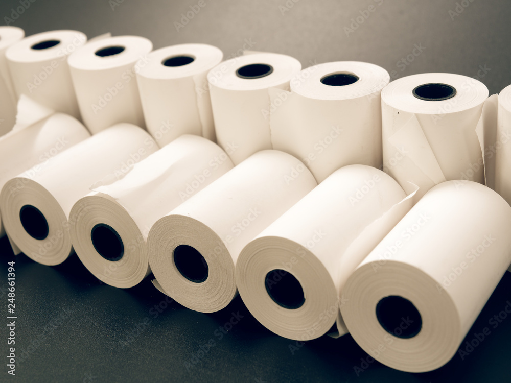 tape of white paper for cash on a black background. tape of white paper for cash on a black background.