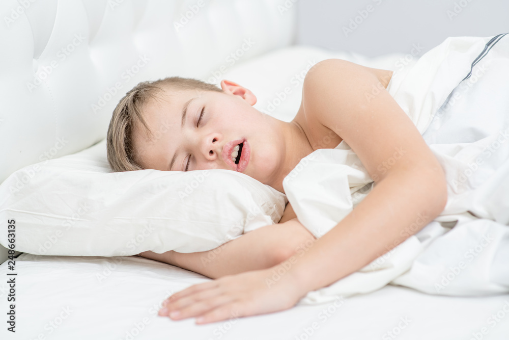 Little boy is sleeping with his mouth open, snoring Little boy is sleeping with his mouth open, snoring