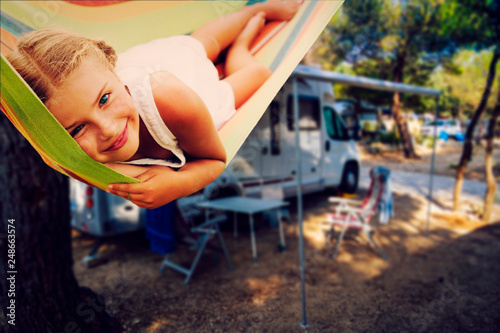 Camping RV travel with camper, summer beach. Happy smiling beauty girl on mototorhome vacation.
