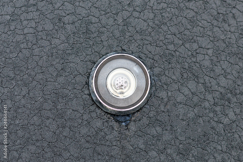 steel door. view from the street. peephole from the temperature drop is all in the bubbles.