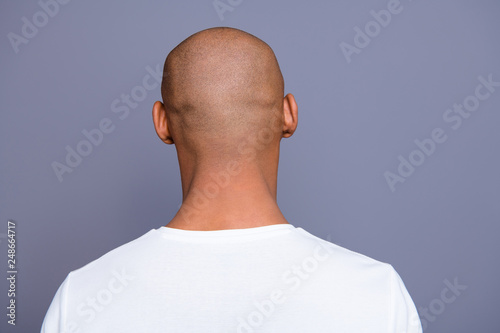 Close up back behind rear view photo dark skin he him his man turned to empty space distracted unrecognizable groomed shaved head wearing white t-shirt outfit clothes isolated on grey background photo