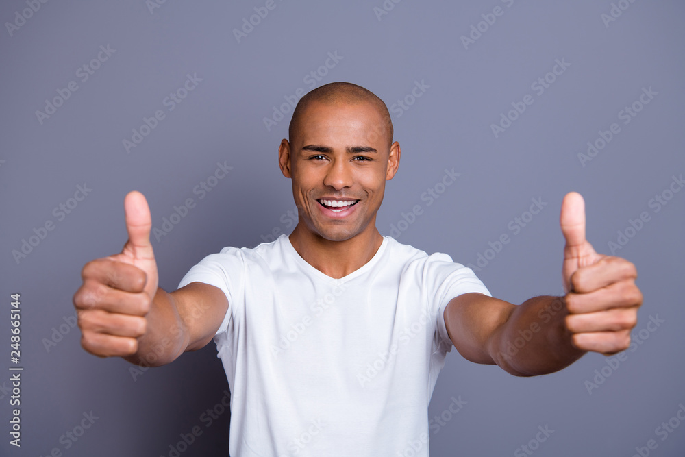 Close up photo strong healthy teeth dark skin he him his guy bald head approve show thumbs fingers up advise buy buyer new product wearing white t-shirt outfit clothes isolated grey background Close up photo strong healthy teeth dark skin he him his guy bald head approve show thumbs fingers up advise buy buyer new product wearing white t-shirt outfit clothes isolated grey background