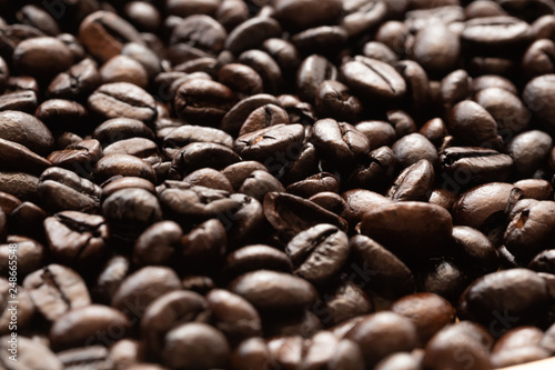 Heap of dark color of raw coffee beans texture for background.