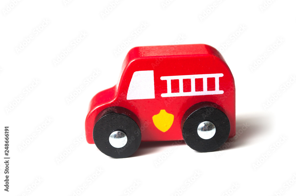 closeup of red miniature wooden truck on white background - concept fire rescue closeup of red miniature wooden truck on white background - concept fire rescue