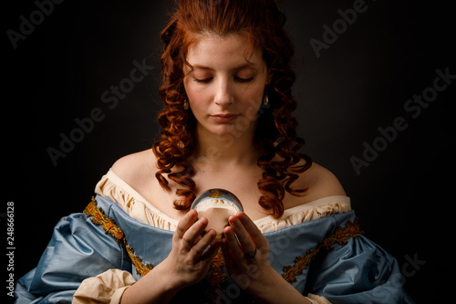 Baroque woman with glass ball photo