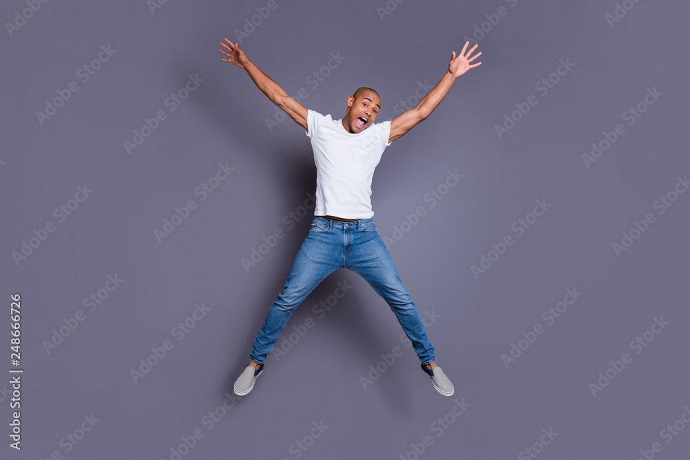 Full length body size portrait of his he nice handsome attractive masculine virile guy wearing white shirt jeans having fun isolated over gray violet purple pastel background