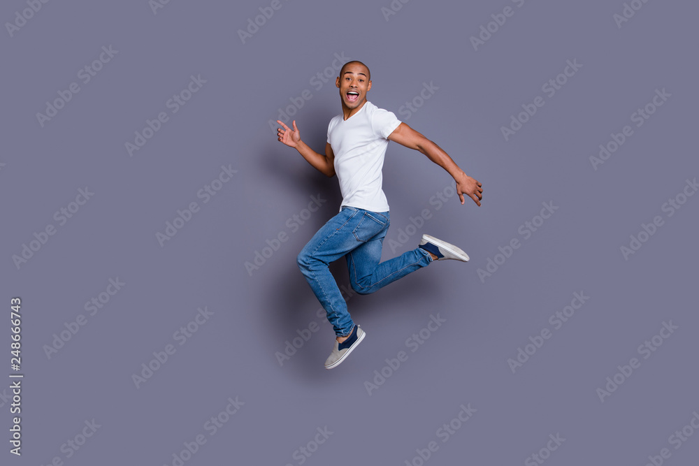 Full length body size portrait of his he nice cool handsome attractive masculine cheerful guy wearing white shirt jeans having fun isolated over gray violet purple pastel background Full length body size portrait of his he nice cool handsome attractive masculine cheerful guy wearing white shirt jeans having fun isolated over gray violet purple pastel background