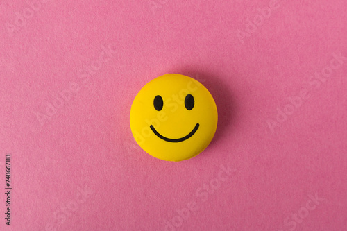 Funny smiley face on pink background. Positive mood. Empty text space.
