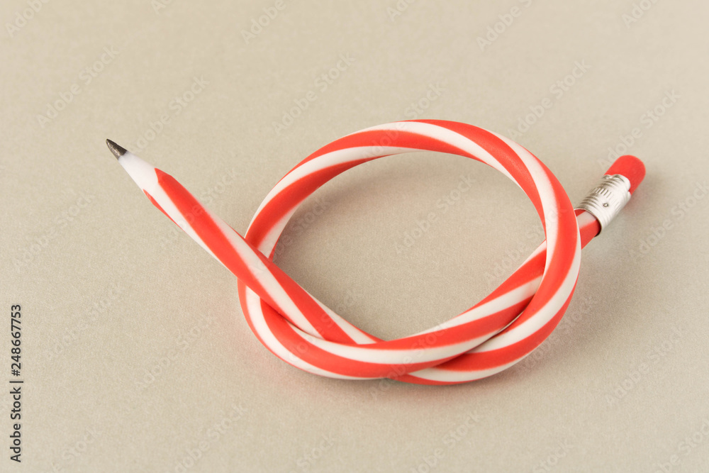 Flexible pencil . Isolated on grey background. Bending pencil.