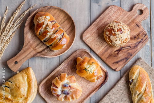 Variery of Bakery bread on wooden chopping board. photo