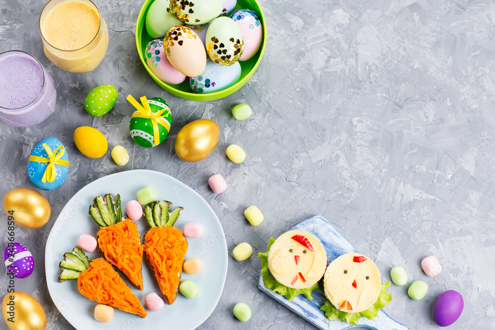 Funny colorful Easter food for kids with decorations on table. Easter dinner concept