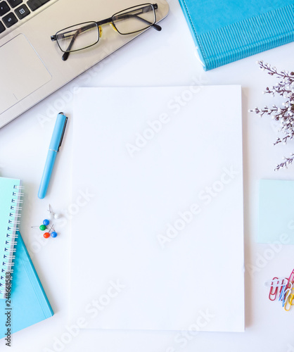 Home office workspace mockup.Workspace top view, copy space.White desk office with blank notebook, computer and other office supplies. Flat lay, top view office table desk.Minmal workspace.