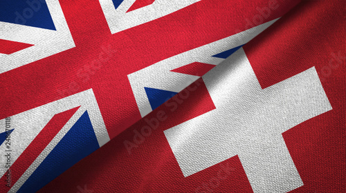 United Kingdom and Switzerland two flags textile cloth, fabric texture photo