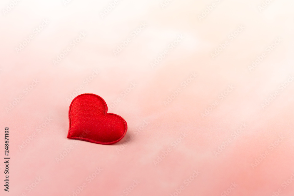 Fototapeta premium Valentines day background with red hearts on pink backdrop. - Love and care concept.