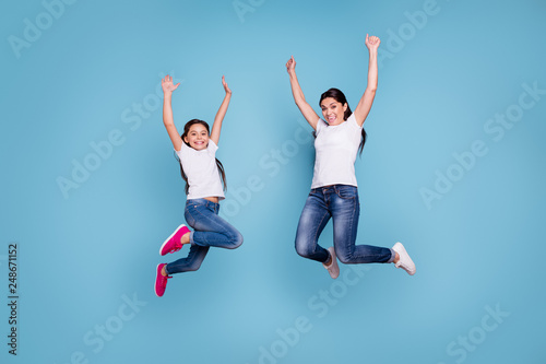 Full length body size view of two nice-looking cute lovely winsome attractive cheerful cheery slim sporty people wearing white t-shirt raising hands up isolated over blue pastel background